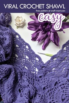 the crochet shawl pattern is shown with purple flowers and yarn on it