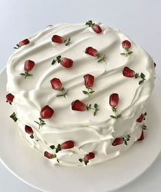 a cake with white frosting and strawberries on it