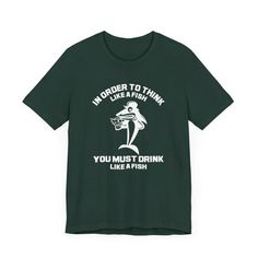 Elevate your casual wardrobe with this hilarious "In Order To Think Like A Fish, You Must Drink Like A Fish" T-shirt. Designed for those who appreciate a good laugh, this funny fishing shirt seamlessly blends drinking humor with a playful aesthetic. Featuring a whimsical design of a shark holding a mug of beer, it's the perfect fisherman shirt for your next fishing trip or casual outing. This fishing trip clothing not only showcases your passion for the sport but also adds a touch of personality Mug Of Beer, Playful Aesthetic, Funny Fishing Shirts, Funny Fishing, Drinking Humor, Whimsical Design, Fishing Humor, Fishing Outfits, Fishing T Shirts