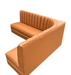 a tan leather couch sitting on top of a white floor