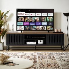 a flat screen tv sitting on top of a wooden entertainment center