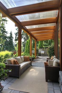 Covered patio with wicker furniture and a view of lush greenery. Patio Covering Ideas, Backyard Cover, Patio Cover Ideas, Inexpensive Patio, Gazebo Garden, Green Roof System, Retractable Shade, Retractable Pergola, Patio Cover