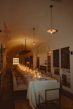 the long table is set up with many glasses and candles for dinner guests to enjoy