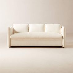 a white couch sitting on top of a hard wood floor