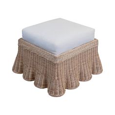 a wicker ottoman with a white cushion on it's top and bottom layer