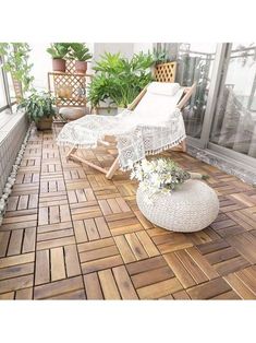 a patio with chairs and potted plants on it