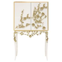 a white and gold cabinet with flowers on it