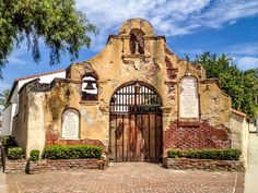 an old church with brick walls and arched doors