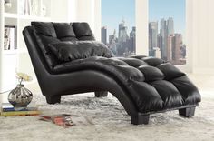 a black leather chaise lounge chair and ottoman