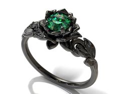 "This ring made for the nature lover between you, It's a unique ring made of 14K black gold with a sparkling of natural Colombian emerald, Let her say \"I do\" with such as unique ring as the one you saw here. ★See A Video Of This Amazing Ring Here★ https://youtu.be/txpgvL7bdV4 Details: SKU:fle24em Gem Details: Center Gem: Emerald - Colombia - Natural Or High-quality Lab made Carat Weight: Choose weight from the variations button. Color/Clarity : Forest Green/VS Size/Cut/Shape: Round Cut, very g Flower Engagement Ring Set, Green Wedding Rings, Lotus Ring, Nature Inspired Engagement Ring, Black Gold Ring, Leaf Engagement Ring, Cute Engagement Rings, Flower Engagement Ring, Magical Jewelry