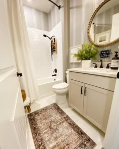 a bathroom with a rug, sink and toilet in it's centerpieces