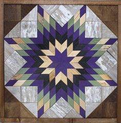 a wooden wall hanging with a purple and green star design on the inside of it