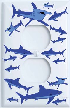 a light switch cover with blue sharks on it