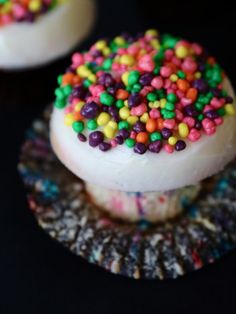 two desserts with sprinkles on top of each one sitting on a plate