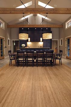 a dining room table and chairs with lights on