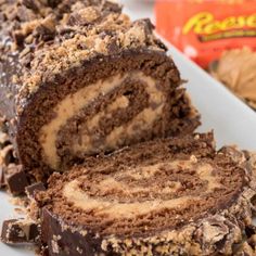 there is a piece of chocolate marble roll on the plate next to some candy bars