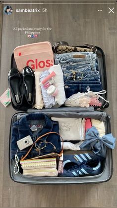 an open suitcase filled with clothes and other items