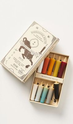 an open box filled with different colored candles