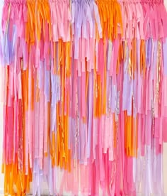 colorful streamers are hanging on the wall