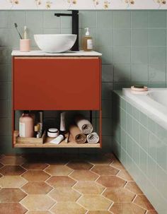 a bathroom with a sink, bathtub and toiletries on the shelf next to it