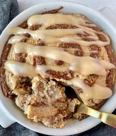 a white bowl filled with food covered in icing