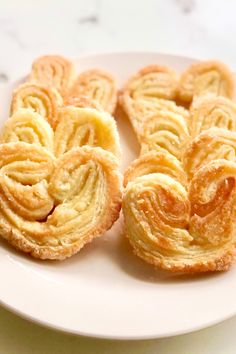 four small pastries on a white plate