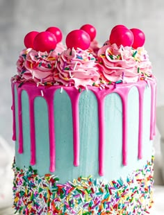 a birthday cake with sprinkles and pink frosting