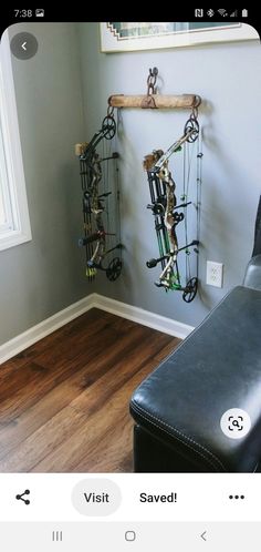 a room with a chair and a wall mounted archery rack on it's side