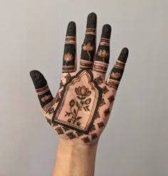 a person's hand is decorated with hennap and floral designs on it