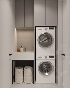 a washer and dryer in a small laundry room with white walls, flooring and cabinets