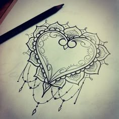 a drawing of a heart on a computer screen with a pen next to it and an image of a flower in the shape of a heart