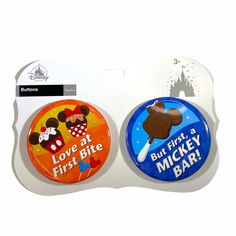 two button badges with mickey and minnie mouse on them, one is for love at first bite