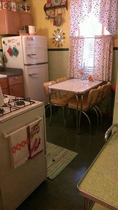 a kitchen with a table, stove and refrigerator