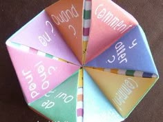 an origami style umbrella with words written on the top and bottom half in different colors