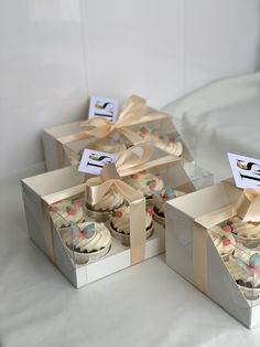 three boxes that have cupcakes in them