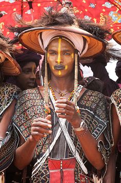 a group of people with painted faces and headdresses