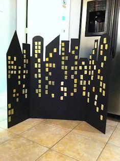 a black and yellow cityscape is on display in front of a refrigerator door