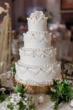 a white wedding cake sitting on top of a table