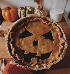 a pumpkin pie sitting on top of a wooden table