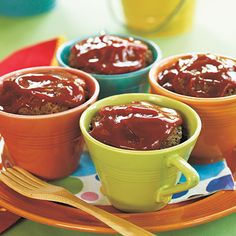 three small cups filled with food on top of a plate next to utensils