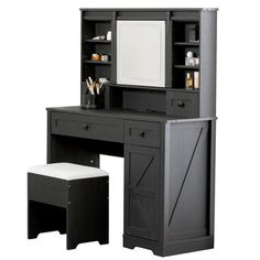 a black desk with a mirror and stool