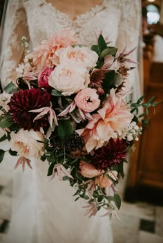 a bride holding a bouquet of flowers in her hands