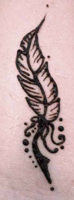 a tattoo design on the back of a woman's stomach, with black ink