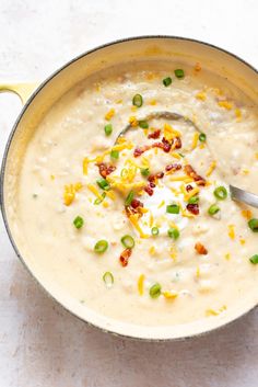 a pot filled with soup and topped with cheese