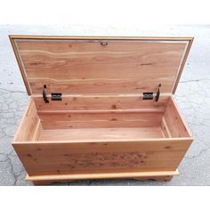 an open wooden box sitting on the ground