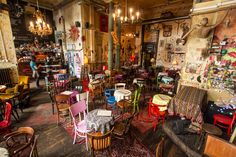 a room filled with lots of different colored chairs and tables next to eachother