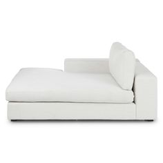 a white couch sitting on top of a white floor