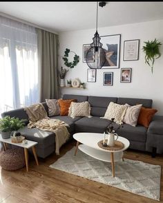 a living room filled with lots of furniture and pictures on the wall above it's windows