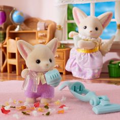 two small toy animals are playing with toys