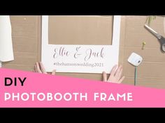 a photo booth frame with scissors and other items on the wall in front of it